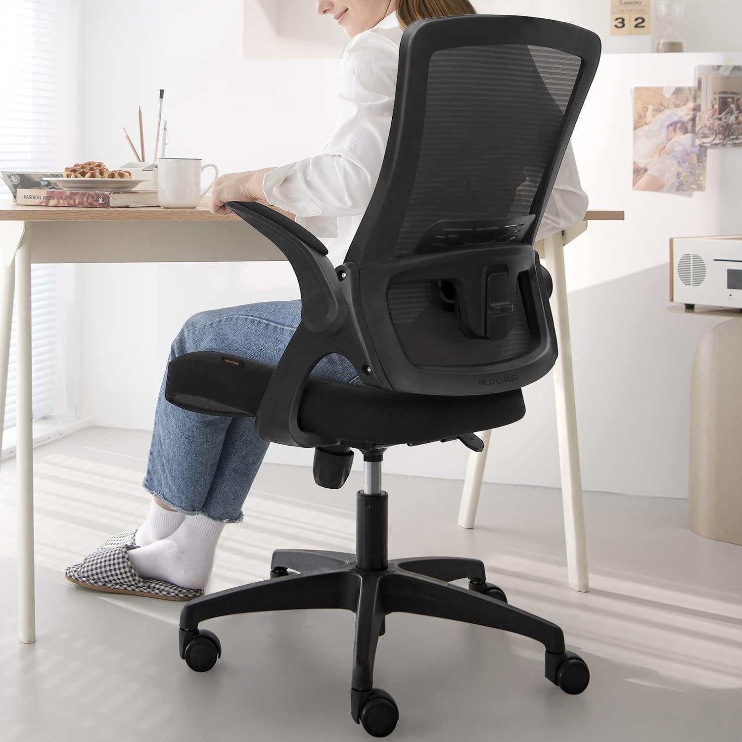 Black Desk Desk being used by a woman.