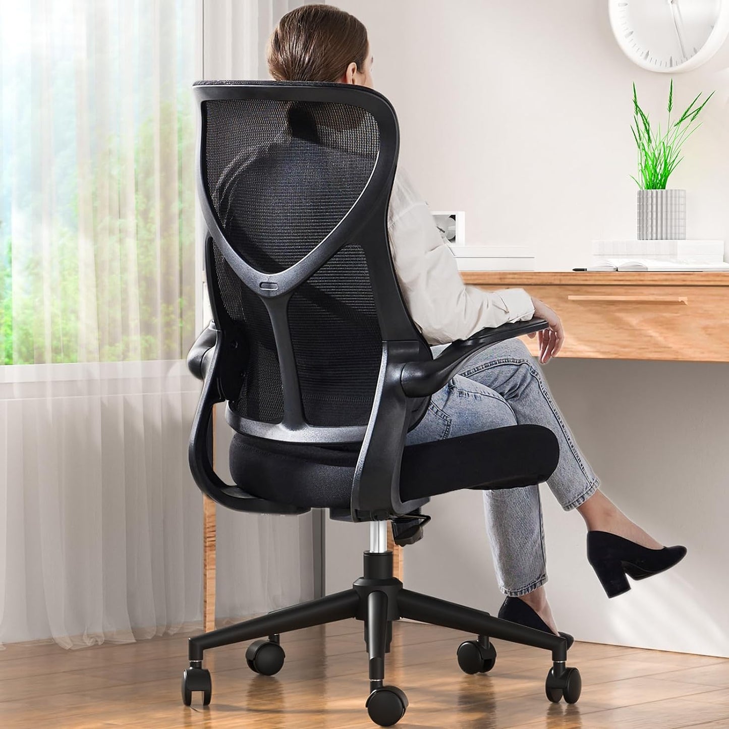 Office Chair with a woman on top looking at a desk.