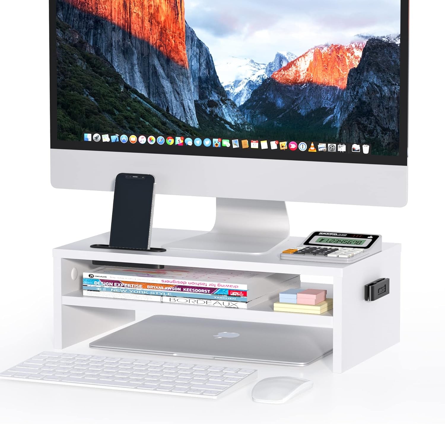 White Monitor Stand with a monitor at the top, a phone, a calculator, and some books.