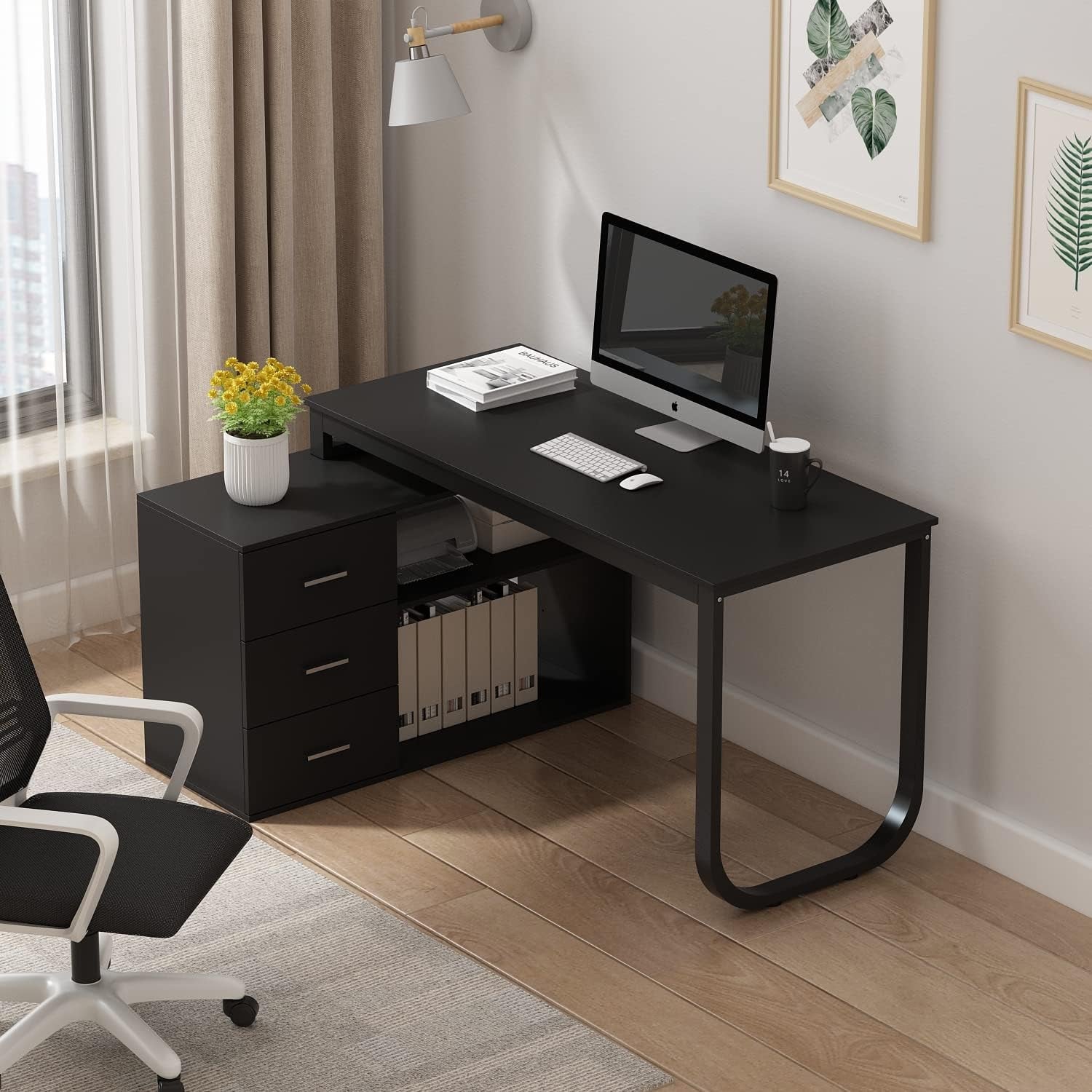 L Shape Black Desk with a computer and a coffee on top of it .